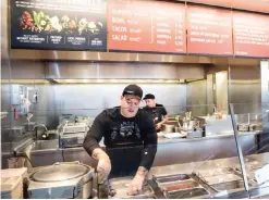  ??  ?? SEATTLE: In this Dec 15, 2015, file photo, a Chipotle Mexican Grill employee prepares food. After an E. coli outbreak that sickened more than 50 people, Chipotle is changing its cooking methods to prevent the nightmare situation from happening again. —...
