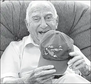  ?? Arkansas Democrat-Gazette/THOMAS METTHE ?? World War II veteran Charlie Ball, 94, shows off his P-40 Warhawk hat Friday. A P-40 plane similar to the one that Ball flew during training will be taking part in today’s air show in North Little Rock.