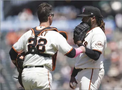  ?? JEFF CHIU — THE ASSOCIATED PRESS ?? San Francisco Giants pitcher Johnny Cueto, right, stands on the mound as catcher Buster Posey (28) approaches during the third inning Sunday against the San Diego Padres in San Francisco.