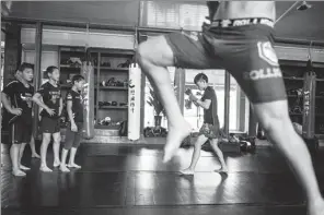  ?? FRED DUFOUR / FOR CHINA DAILY ?? Youngsters practice mixed martial arts at the Enbo MMA Club in June in Chengdu, Sichuan province.