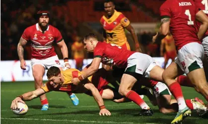  ?? Photograph: Gareth Copley/Getty Images ?? Dan Russell scores the fourth try for Papua New Guinea in their win against Wales.