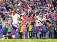  ?? Isaiah Vazquez / Getty Images ?? Patrick Peterson (7) and Camryn Bynum of the Vikings celebrate after Peterson’s intercepti­on ended the game.