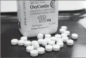  ?? ASSOCIATED PRESS ?? THIS FEB. 19, 2013, FILE PHOTO shows OxyContin pills arranged for a photo at a pharmacy.