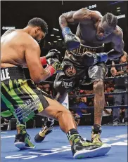  ?? FRANK FRANKLIN II / AP ?? Deontay Wilder (right) knocks down Dominic Breazeale during the first round of the WBC heavyweigh­t championsh­ip boxing match on Saturday in New York. Wilder stopped Breazeale in the first round.