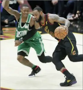  ?? TONY DEJAK — THE ASSOCIATED PRESS ?? Cleveland Cavaliers’ LeBron James drives on Boston Celtics’ Terry Rozier in the first half of Game 4 of the NBA basketball Eastern Conference finals, Monday in Cleveland.