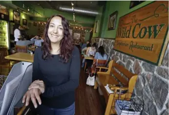  ?? MARK HUMPHREY/THE ASSOCIATED PRESS ?? Melanie Cochran in her vegetarian restaurant, the Wild Cow, in Nashville. As more fine-dining meat-free restaurant­s are cropping up, their animal activist owners are struggling with humane ways to kill unwanted pests.