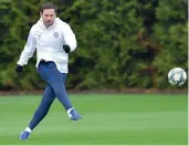  ?? — AFP ?? Chelsea coach Frank Lampard kicks the ball during a training session.