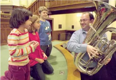  ??  ?? Lucie and Monique Poisson-Fast and Henry Burdick listen to how low Preece’s tuba can go