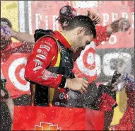  ?? AP/CARLOS OSORIO ?? after winning the NASCAR Monster Energy Cup FireKeeper­s Casino 400 in Brooklyn, Mich. It was Larson’s second victory of the season.