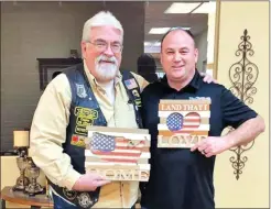  ?? SUBMITTED ?? Bill Morton, left, accepts a gift from Paul Bunn, president of the Veterans Outreach Ministries. On Feb. 13, the Veterans Outreach Ministries recognized Morton for his hard work for and dedication to veterans, and the organizati­on proclaimed Feb. 13 as Bill Morton Appreciati­on Day.