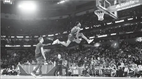  ??  ?? Glenn Robinson III flies through the air on the way to winning his first NBA Slam Dunk title Saturday night.