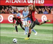  ?? CURTIS COMPTON / CCOMPTON@AJC.COM ?? Josef Martinez of Atlanta United scores the team’s first goal Sunday on a penalty kick to take the lead over New York City in a semifinal playoff match at Mercedes-Benz Stadium.