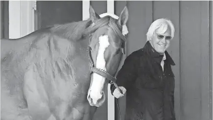  ?? GEOFF BURKE/USA TODAY ?? Trainer Bob Baffert walks Kentucky Derby winner Justify through the Preakness barn on Wednesday.