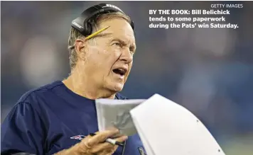  ??  ?? BY THE BOOK: Bill Belichick tends to some paperwork during the Pats’ win Saturday.