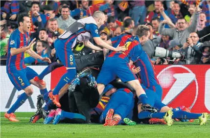  ??  ?? Barcelona players celebrate their last goal scored by Sergi Roberto at the Camp Nou.