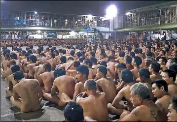  ??  ?? Handout from the Philippine Drug Enforcemen­t Agency-Regional Office 7 taken last Feb. 28 shows naked inmates at the Cebu city jail sitting during a joint raid by the PDEA and the Cebu provincial police office on illegal drugs and contraband.