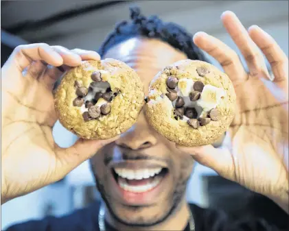  ?? CP PHOTO ?? Yannick Craigwell, of Treatsandt­reats, shows off some of his edible marijuana baked treats in Vancouver recently.