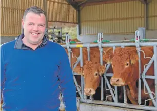  ??  ?? Chris Cameron with some of his pedigree Limousin cows.
