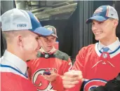  ?? GRAHAM HUGHES/THE CANADIAN PRESS ?? Juraj Slafkovsky, right, of Slovakia, greets countryman and fellow Canadiens pick Filip Mesar, left, as Simon Nemec, also from Slovakia and a Devils pick, looks on at the NHL draft.
