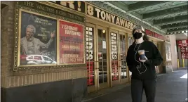  ?? Photos and text from The Associated Press ?? A woman walks past the Walter Kerr Theatre, where Hadestown will reopen.