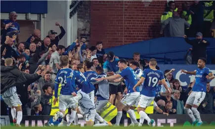  ?? Photo / Getty Images ?? Everton’s players and fans celebrate Dominic Calvert-Lewin’s goal which gave their team a late lead.