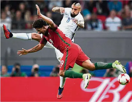  ??  ?? Up in the air: Portugal’s Eliseu (front) vying for the ball with Chile’s Arturo Vidal. — AFP