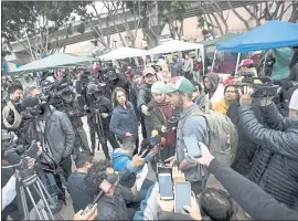  ?? HANS-MAXIMO MUSIELIK — THE ASSOCIATED PRESS ?? While a press conference was conducted earlier this week, a group of Central American migrants set up camp to wait for access to request asylum in the U.S., outside the El Chaparral port of entry building at the US-Mexico border in Tijuana.