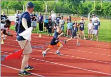  ?? DIGITAL FIRST MEDIA FILE PHOTO ?? Kids race from the start line during a 200-meter dash for The Hill School community track night in Pottstown. Children ages 2 to 14 competed in different distance runs and other track events such as the softball throw and long jump.