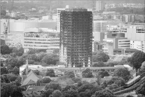  ?? — Reuters photo ?? The burnt out remains of the Grenfell apartment tower are seen in North Kensington, London.