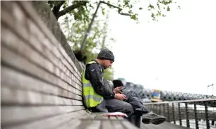  ?? — REUTERS FILE ?? A man checks his phone in the city centre of Dublin, Ireland. Under the new EU rules, mobile software makers are required to show a choice screen where users can select a browser, search engine and virtual assistant as they set up their phones.