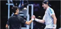  ?? – AFP ?? WEEL DONE: Novak Djokovic shakes hands with John Isner after winning at the ATP World Tour Finals in London.
