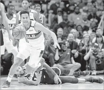  ?? Matthew Hinton Associated Press ?? FRANK JACKSON of the Pelicans takes the ball from Brandon Ingram, one of 23 turnovers by the Lakers. New Orleans played without All-Star forward Anthony Davis, but it didn’t matter in this one.