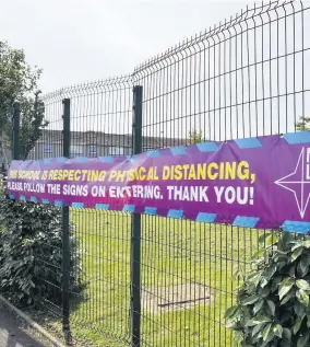  ??  ?? Taking precaution­s A banner outside Airdrie’s Caldervale High saying the school is “respecting physical distancing”