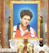  ?? GREGORIO BORGIA AP ?? An image of 15-year-old Carlo Acutis is seen during his beatificat­ion ceremony celebrated by Cardinal Agostino Vallini (center) in Assisi, Italy, on Saturday.
