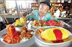  ?? TORU YAMANAKA/AFP ?? Norihito Hatanaka, president of Fake Food Hatanaka, shows plastic food dishes at his company’s studio on January 18, in Tokorozawa, a suburb of Tokyo.