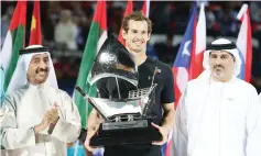  ?? - AFP photo ?? World number one Andy Murray of Great Britain celebrates with the championsh­ip trophy after winning his ATP final tennis match against Spain’s Fernando Verdasco, during the Dubai Duty Free Championsh­ips on March 4, 2017. Murray clinched his first title...