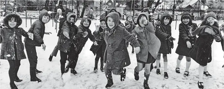  ??  ?? Charge! Children at Walton-on-the Hill County School pelt the photograph­er with snowballs in 1977. No winter footwear here: it’s Start-rite shoes and sandals instead