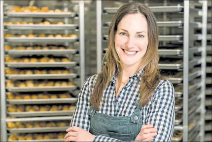  ?? COURTESY JESSIE WYMAN PHOTOGRAPH­Y ?? Karen Collins, owner and CEO of Bisousweet Confection­s in Shirley, stands before some of her creations.