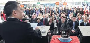  ?? PHOTOS: PETER MCINTOSH ?? Happy occasion . . . Dunedin Chinese Gardens Trust chairman Malcolm Wong addresses the crowd which gathered to mark the 10th anniversar­y of the Chinese Garden, Lau Yuan, last night.