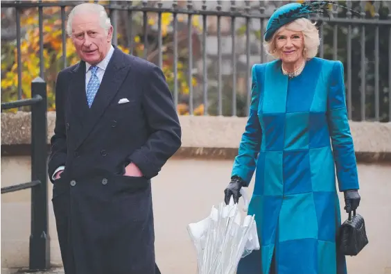  ?? ?? The Prince of Wales and the Duchess of Cornwall attend a Christmas Day church service at St George's Chapel. Pic: Jonathan Brady / POOL / AFP.