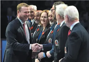  ?? CP PHOTO ?? Hockey Hall of Fame inductee Martin Brodeur shakes hands with HHOF personalit­ies before an NHL game between the Toronto Maple Leafs and New Jersey Devils in Toronto on Friday.