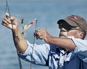  ?? Photograph­s by Al Seib Los Angeles Times ?? WICK WRIGHT prepares to fish at Castaic Lake in June. He said it was easier to fish in the drought-stricken version of the massive reservoir. “Toward the end of the drought there was no place for the fish to hide.”