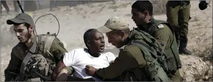  ??  ?? In this June 27, 2014, file photo, African migrants clash with Israeli soldiers after they left Holot detention center in southern Israel and walked towards the Border with Egypt near the southern Israeli Kibbutz of Nitzana. Tens of thousands of...