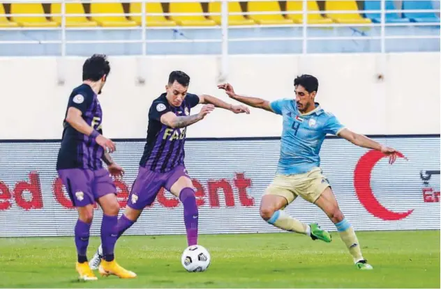  ??  ?? ↑
Players of Al Dhafra and Al Ain fight for the ball during their Arabian Gulf League match on Thursday.