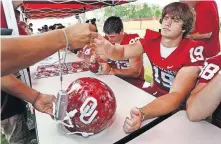  ??  ?? OU tight end Joe Jon Finley (19) signs autographs during the Sooners' fan day on Aug. 3, 2007. Finley has returned to OU as associate head coach for offense. [CHRIS LANDSBERGE­R/ THE OKLAHOMAN]