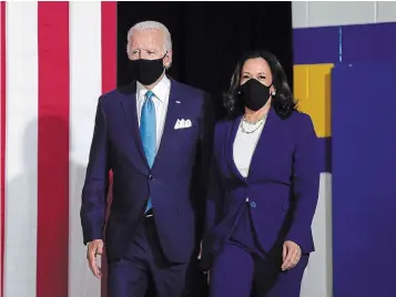  ?? OLIVIER DOULIERY AFP VIA GETTY IMAGES ?? Democratic presidenti­al nominee Joe Biden and running mate Kamala Harris arrive at their first press conference in Delaware on Wednesday. The audience consisted entirely of journalist­s, campaign staff and family members.