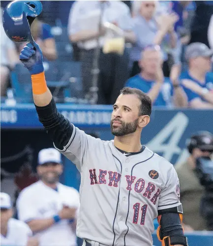  ?? FRED THORNHILL / THE CANADIAN PRESS ?? Slugger and longtime Toronto fan favourite Jose Bautista acknowledg­es a cheering crowd before his first at-bat as the New York Mets visited the Blue Jays at the Rogers Centre on Tuesday night.