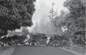  ?? Provided by the U.S. Geological Survey, via AFP ?? Lava flows last Sunday on Makamae Street in Leilani Estates, near Pahoa, Hawaii.