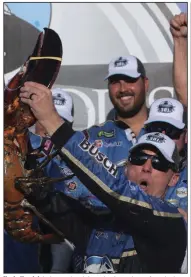  ?? (AP/Charles Krupa) ?? Kevin Harvick hoists a giant lobster in victory lane after winning a NASCAR Cup Series auto race at New Hampshire Motor Speedway in Loudon, N.H., in 2019. Harvick has won four races this year and is chasing Denny Hamlin, who has won five races.