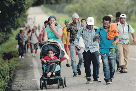  ?? Maria de la Luz Ascencio EPA/Shuttersto­ck ?? THE CARAVAN of migrants, most from Honduras, walk northward in southern Mexico. Some migrants, beset by dehydratio­n and exhaustion, have turned back toward their homes. Mexican authoritie­s have not made much effort to stop those who continue to head north.